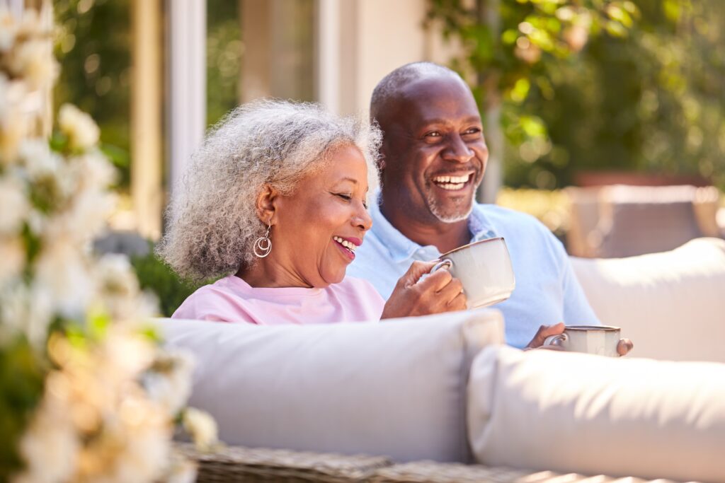 Retired,Couple,Sitting,Outdoors,At,Home,Having,Morning,Coffee,Together