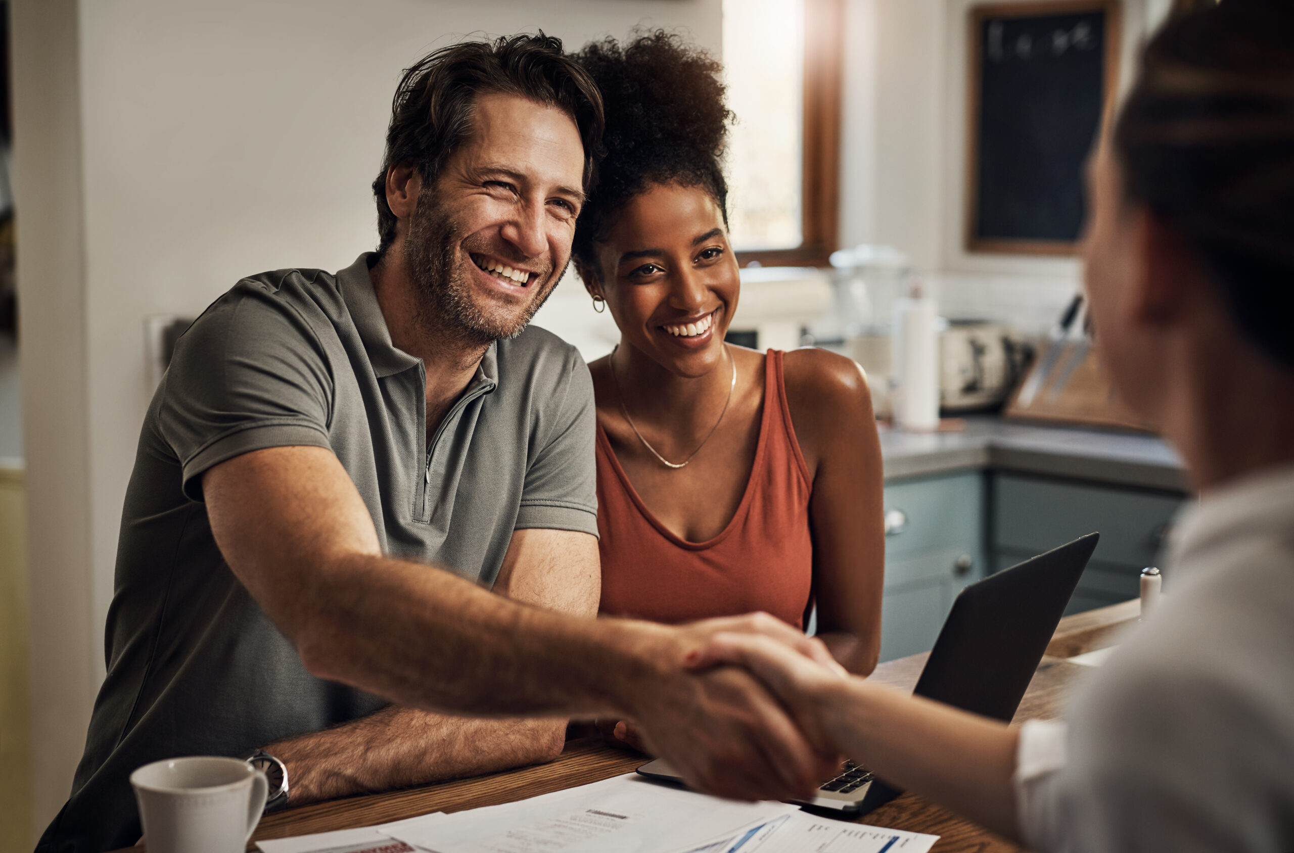Thank you so much for your assistance. Cropped shot of a handsome middle aged man shaking hands with a financial advisor during a consultation at home. Cropped shot of a handsome middle aged man shaking hands with a financial advisor during a consultation at home